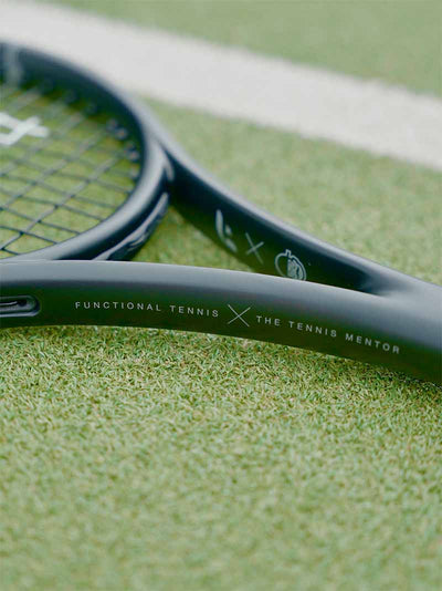 Close-up of a the Saber with tennis mentor collab branding on a blurred background