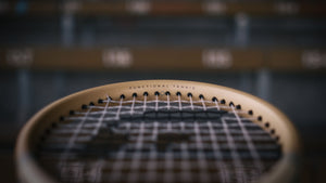 Close-up of a vintage edition saber with 'Functional Tennis' branding on a blurred background